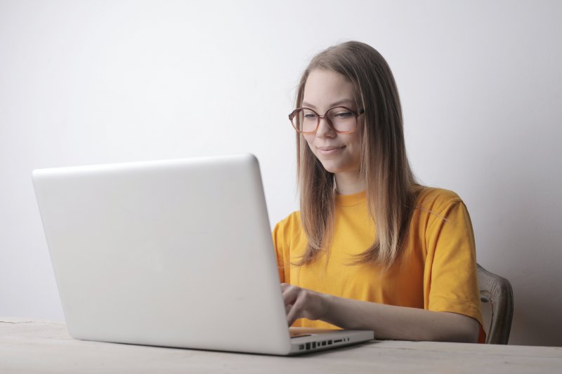 Una chica escribe una carta de presentación en un ordenador portátil